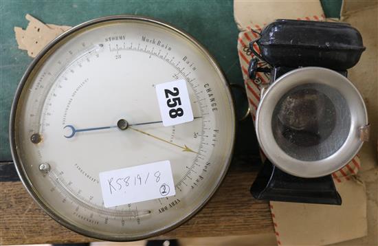 A brass aneroid barometer and twin thermometer and a three stars cycle lamp